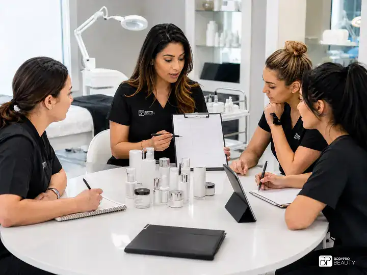 Students learning client consultation, treatment planning, communication, and business management skills for professional aesthetics careers.